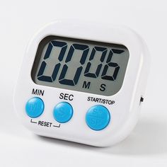 an alarm clock sitting on top of a white table