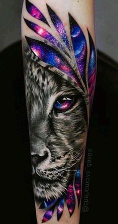 a colorful tattoo with a lion's face and feathers on the arm, it looks like