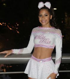 a woman in a cheerleader outfit posing for the camera