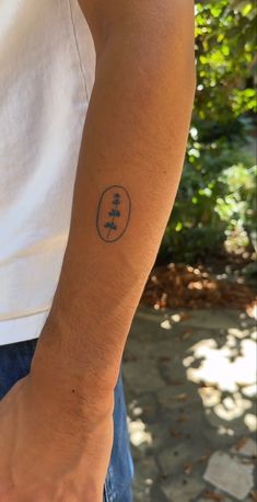 a man with a small tattoo on his arm