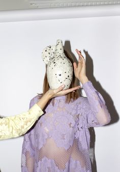 two women holding up stuffed animals to their faces