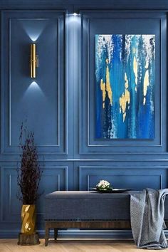 a living room with blue walls and gold accents on the wall, along with a bench