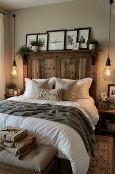 a bed with pillows, blankets and pictures on the headboard in front of a window