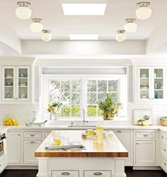 an image of a kitchen with white cabinets and counter tops, as well as pictures on the phone