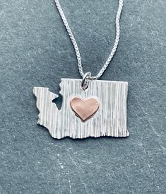 Do you love where you live? Take a bit of 'home' with you wherever you go with this WA state necklace. This sterling silver necklace has a textured surface and a contrasting copper metal heart soldered on. It's approximately 1 inch wide and comes on a silver chain. Each necklace is created by hand so subtle differences are to be expected. Nana Necklace, Wa State, Metal Heart, Copper Metal, Star Necklace, Sterling Silver Necklace, Sterling Silver Necklaces, Post Earrings, Pendant Necklaces