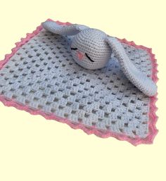 a crocheted blanket with a stuffed animal on it