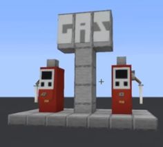 two gas pumps sitting next to each other in front of a sign that says gas