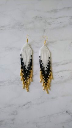 Alabaster white, black, and gold hand beaded seed bead earrings. 4" hang Indigenous Beaded Earrings, Earring Inspired, Miyuki Beads Pattern, Earring Inspo, Stitch Earrings, Homemade Earrings, Beaded Things, Beads Pattern, Alabaster White