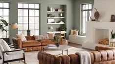 a living room filled with lots of furniture next to a fire place in a fireplace