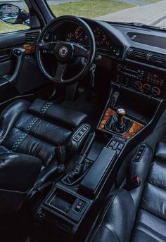 the interior of a car with black leather seats and steering wheel, dashboard, dash board and instrument panel