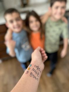 three children holding hands with the words hello mate fun written on their arm in front of them