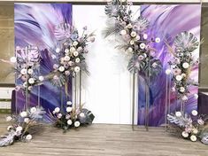 two tall floral arrangements with purple and white flowers