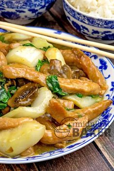 a close up of a plate of food with chopsticks