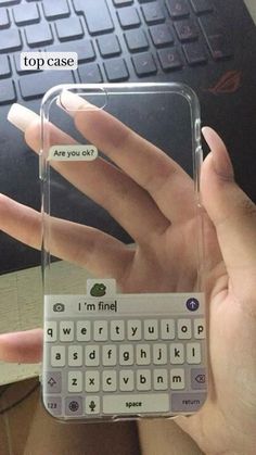 someone is holding up their phone case with the keyboard on it