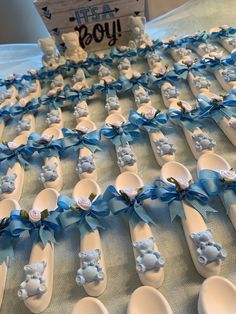 many baby blue and white spoons with teddy bears on them