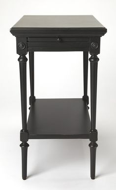 a black end table with one drawer and two legs