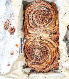 a loaf of cinnamon swirl bread sitting on top of parchment paper