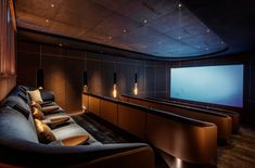 an empty theater with seats and a projector screen