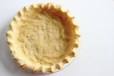 an uncooked pie crust on a white surface