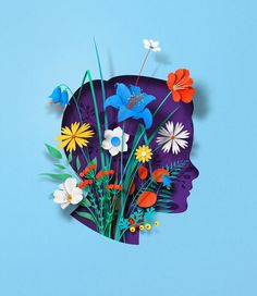 a paper cut out of a woman's head with flowers and butterflies on it