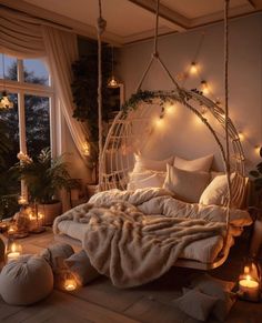 a bed with pillows, blankets and lights around it