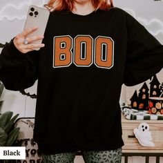 Boo sweatshirt for spooky season! Distressed design printed on unisex Gildan 1800 crewneck sweaters perfect for wearing or gifting! Size up for an oversized fit :)  ✨ Free shipping on your entire order! ✨  Product color may vary slightly due to variation in photographic lighting and screens/monitors displaying colors differently. When ordering and choosing your size, please keep the unisex fit in mind. If you find your size is out of stock (these are well-loved!) consider sizing up for that over Black Pre-shrunk Sweatshirt For Fall, Oversized Pre-shrunk Sweatshirt For Fall, Spooky Sweatshirt For Fall, Oversized Spooky Sweatshirt For Fall, Spooky Cotton Sweatshirt For Fall, Black Crew Neck Halloween Sweatshirt, Oversized Spooky Halloween Sweatshirt, Oversized Sweatshirt, Fall Sweaters