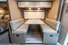 the inside of a camper with couches and tables in it's center