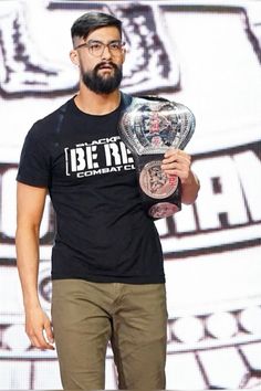 a man holding a wrestling belt in his hand