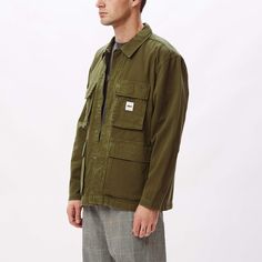 The Peace BDU (Battle Dress Uniform) jacket is constructed of 100% organic cotton and features a vintage look, full-zip closure with snap placket closure, four button closure pockets at front and a woven logo label sewn at chest. 100% organic cotton. Machine wash cold. Imported. By OBEY.Style: 121800440 Streetwear Long-sleeve Shacket With Snap Buttons, Streetwear Long Sleeve Shacket With Snap Buttons, Outdoor Cotton Utility Jacket With Pockets, Long Sleeve Shacket With Snap Buttons For Streetwear, Cotton Outerwear With Snap Buttons, Utility Cotton Outerwear With Pockets, Utility Long Sleeve Cotton Outerwear, Cotton Utility Outerwear With Pockets, Cotton Utility Jacket With Long Sleeves For Streetwear