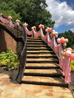 a set of stairs decorated with balloons and streamers for an outdoor wedding or baby shower