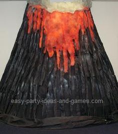 a skirt made out of sticks with orange and white paint on the bottom, hanging from a wall