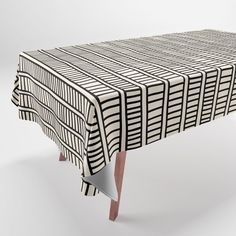 a black and white table cloth with lines on it, sitting in front of a white background