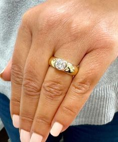 a woman's hand with a yellow and white diamond ring on her left finger