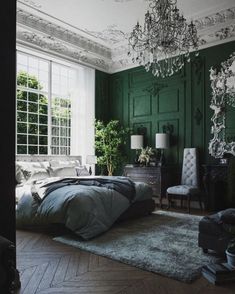 a bedroom with green walls and white trim on the ceiling is decorated in an elegant manner