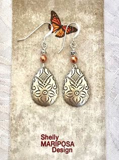 Etched silver and copper Boho teardrop earrings 🌸 These beautiful earrings are VERY lightweight! The silver and copper are a great combination with floral etching on the silver pieces. These earrings are 1.5 inches xlong and a half inch wide. Weight is 2.0 grams. French earwires are sterling silver. All my jewelry comes gift boxed with a custom Shelly Mariposa Design butterfly card ready for gift giving, whether it is a gift for you or someone special. Your satisfaction is very important to me. Artisan Silver Drop Earrings, Silver Drop Artisan Earrings, Artisan Silver Teardrop Earrings, Bohemian Silver Drop Jewelry, Metal Dangle Jewelry With Etched Details, Silver Teardrop Stamped Jewelry, Silver Engraved Teardrop Earrings, Etched Metal Dangle Jewelry, Handmade Silver Ornate Teardrop Earrings