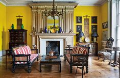 a living room filled with furniture and a fire place in the middle of a room