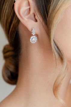 a close up of a woman's ear wearing earrings