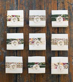 wedding rings and napkins laid out on a wooden table