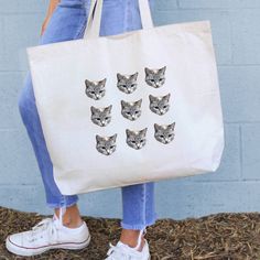 A super cute tote that every cat mom will love. Send us the best photos of your cat(s) and we'll create this fun bag is perfect for shopping trips and other outings. A great gift idea for any occasion, the design is digitally printed for a unique and one-of-kind canvas tote. - You submit the photo and our design team will clip the photo around the dogs face. (Refer to our photo tips on the images submitted for the best results) - Print-to-order in the USA using eco-friendly water based apparel i Work Purse, Tiny Bag, Bleach Product, Multipurpose Bag, Cat S, Cotton Drawstring Bags, Pet Photo, Crazy Cat, The Crazy