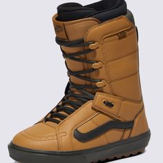 a pair of brown snowboard boots with black laces on the bottom and sides