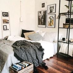 a bedroom with white walls and wooden floors