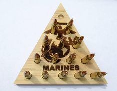 there is a wooden triangle with marine emblems on it