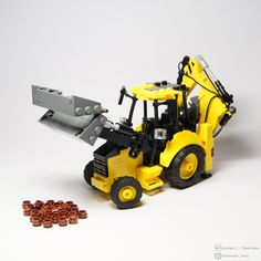 a yellow toy bulldozer with lots of brown legos around it on a white surface