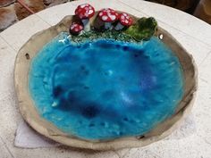 a blue plate with mushrooms on it sitting on a table