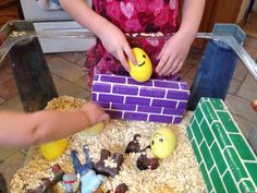 two children are playing with toys made out of lego blocks and bricks on the floor