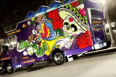 a food truck is decorated with skulls, roses and dia de los muerts