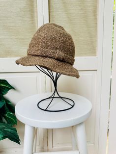 Vintage 40s brown wool/tweed bucket hat.  Made in Italy for Bloomingdales.  50% Wool, 50% Acrylic. Various shades of light brown with a knotted band around the hat.  Interior has a ribbon around the circumference.  In good vintage condition with no stains or holes. Measures approx 20" in circumference. Shipping: USPS Standard Post (insurance tracking included) We are happy to ship internationally! *Due to the variability in shipping costs based on location, anything in excess of $2.00 over the actual cost will be refunded.  We can provide a combined shipping cost and/or estimate to your location. Refunds and Exchanges: All sales are final.  You will not be refunded if an item does not fit. Please check the measurements carefully and ZOOM into photographs to view details.  Please ask any qu Brown Wool Fedora Hat, Classic Brown Bucket Hat With Short Brim, Brown Wool Fedora, Brown Bucket Hat For Fall, Brown Tweed Hat For Fall, Brown Wool Cloche Hat With Curved Brim, Brown Bucket Hat With Curved Brim, Brown Wool Cloche Hat With Short Brim, Brown Brimmed Cloche Hat For Winter