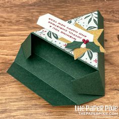 an origami christmas card in a green box