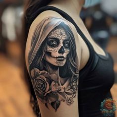 a woman with a skull and rose tattoo on her arm