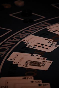 a black table topped with lots of playing cards